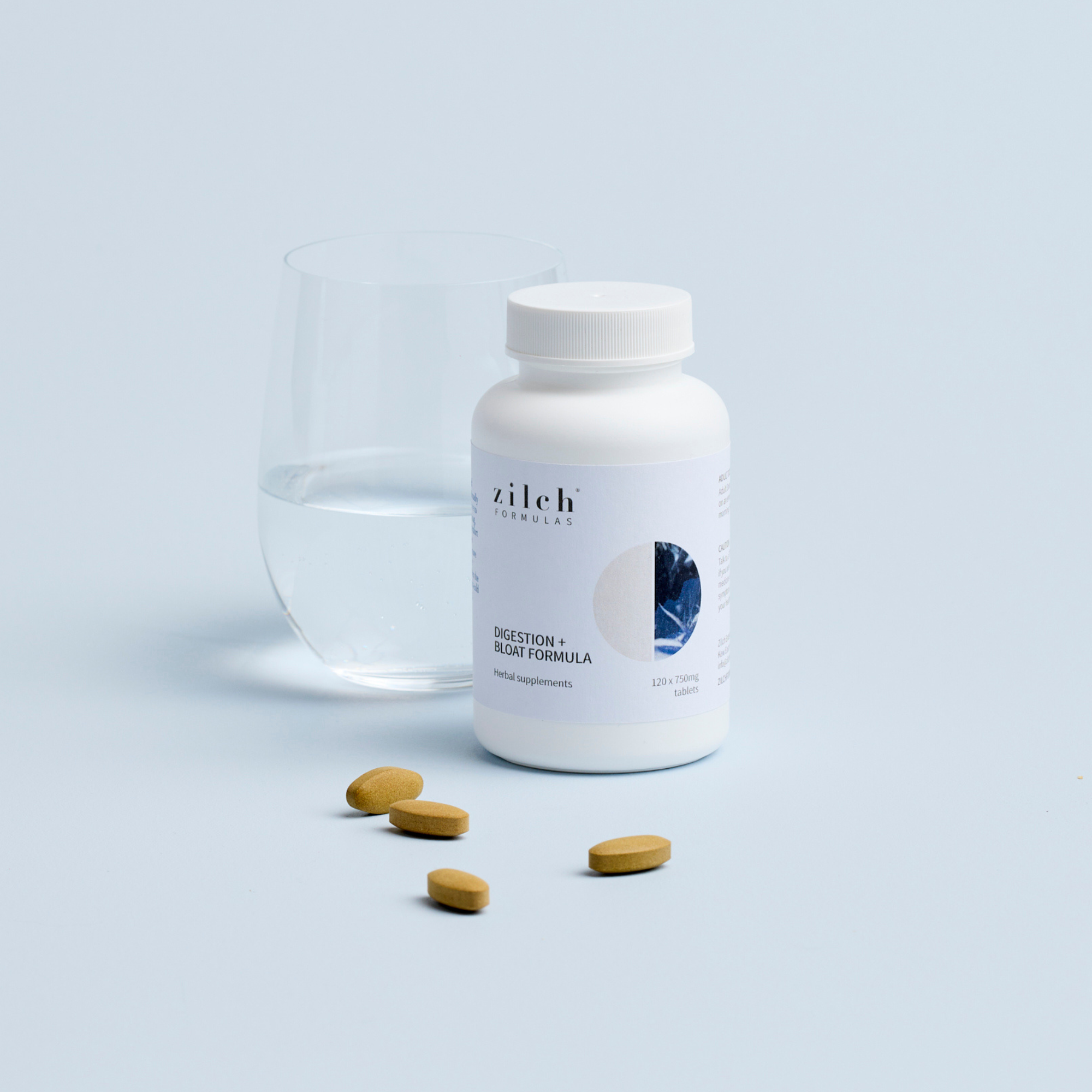 Zilch digestion and bloat formula and glass of water